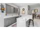 Stylish bar area with sleek gray cabinets, quartz countertops, stainless steel appliances, and chic bar stools at 254 Lead Queen Dr, Castle Rock, CO 80108