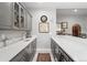 Elegant bar area featuring white quartz countertops, gray cabinetry, a wine cooler, and refined decor at 254 Lead Queen Dr, Castle Rock, CO 80108