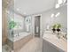 Bright bathroom with a drop-in tub, double vanity, and tile flooring at 254 Lead Queen Dr, Castle Rock, CO 80108
