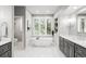 Bright bathroom with a standalone tub, double vanity, and tile flooring at 254 Lead Queen Dr, Castle Rock, CO 80108