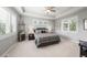 Neutral bedroom with large windows, carpeted floors, and tray ceiling at 254 Lead Queen Dr, Castle Rock, CO 80108