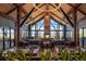 Elegant dining room with high ceilings, stone fireplace, walls of windows, and tastefully set tables at 254 Lead Queen Dr, Castle Rock, CO 80108