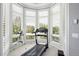 Bright exercise room featuring a treadmill and telescope by a large bay window with plantation shutters at 254 Lead Queen Dr, Castle Rock, CO 80108