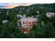 Luxurious multi-story home with manicured landscaping and outdoor patio nestled amongst mature trees in the mountainside neighborhood at 254 Lead Queen Dr, Castle Rock, CO 80108