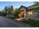 Charming exterior view of home featuring stone accents, a well-manicured lawn and mature trees at 254 Lead Queen Dr, Castle Rock, CO 80108