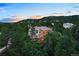 Beautiful home with a manicured lawn, landscape and patio umbrellas nestled in mature trees at 254 Lead Queen Dr, Castle Rock, CO 80108