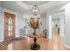 Inviting foyer featuring hardwood floors, elegant lighting, and a decorative table with floral arrangement at 254 Lead Queen Dr, Castle Rock, CO 80108