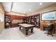 Spacious game room featuring a pool table, custom built-ins, and a dedicated workspace with ample shelving at 254 Lead Queen Dr, Castle Rock, CO 80108