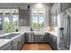This is a spacious kitchen featuring gray cabinetry, stainless steel appliances, and white countertops at 254 Lead Queen Dr, Castle Rock, CO 80108