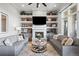 Cozy living room featuring built-in shelving, a fireplace, and comfortable seating at 254 Lead Queen Dr, Castle Rock, CO 80108