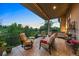 This outdoor patio is covered with comfortable seating and a grill at 254 Lead Queen Dr, Castle Rock, CO 80108