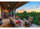 This outdoor patio is covered with comfortable seating and a sunset view at 254 Lead Queen Dr, Castle Rock, CO 80108