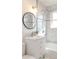 Modern bathroom features marble tile, a stylish vanity, and bright lighting at 1476 W Dakota Ave, Denver, CO 80223