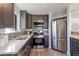 Modern kitchen featuring stainless steel appliances, sleek countertops, and stylish cabinetry at 1476 W Dakota Ave, Denver, CO 80223