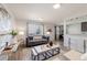 Elegant living room with modern decor, large window, and a seamless transition to the dining area at 1476 W Dakota Ave, Denver, CO 80223