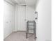 Basement storage area with carpet flooring, metal storage racks, and white doors at 2432 S Newport St, Denver, CO 80224