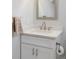 Bathroom featuring a white vanity with quartz countertop and brushed nickel faucet fixtures at 2432 S Newport St, Denver, CO 80224