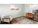 Bright bedroom with a large window, featuring an area rug, desk and leather chair for a modern aesthetic at 2432 S Newport St, Denver, CO 80224