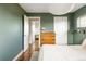 Bedroom featuring hardwood floors, a dresser, and stylish decor at 2432 S Newport St, Denver, CO 80224