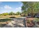 Exterior view of long driveway leading up to house and adjacent to a natural grassy area at 2432 S Newport St, Denver, CO 80224