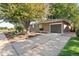 Side view of brick house with a garage and long driveway at 2432 S Newport St, Denver, CO 80224