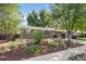 Attractive brick house with front yard featuring mature trees and native landscaping at 2432 S Newport St, Denver, CO 80224