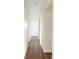 Hallway with hardwood floors and neutral paint, leading to various rooms at 2432 S Newport St, Denver, CO 80224