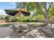 Patio featuring an outdoor table and chairs with a large umbrella and shady tree at 2432 S Newport St, Denver, CO 80224