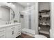 Modern bathroom with a glass enclosed shower, floating shelves, and a white marble vanity at 3107 S Nepal Way, Aurora, CO 80013