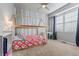 Charming bedroom featuring a bed frame, desk, playful wallpaper, and a large window at 3107 S Nepal Way, Aurora, CO 80013