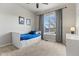 Bright bedroom featuring a ceiling fan, large window, and built in drawers under the bed at 3107 S Nepal Way, Aurora, CO 80013