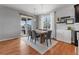 Bright dining room featuring hardwood floors, modern lighting, and a sliding door to the backyard at 3107 S Nepal Way, Aurora, CO 80013