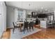 Dining area with a wooden table, modern chairs, and a large window for natural light at 3107 S Nepal Way, Aurora, CO 80013