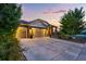 A brick and siding home with a three-car garage at sunset at 3107 S Nepal Way, Aurora, CO 80013