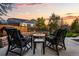 Backyard fire pit with stone surround and outdoor seating at sunset at 3107 S Nepal Way, Aurora, CO 80013