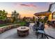 Backyard patio features an outdoor fire pit and comfortable seating at sunset at 3107 S Nepal Way, Aurora, CO 80013