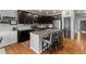 Kitchen featuring dark cabinets, granite countertops, stainless steel appliances, and a central island at 3107 S Nepal Way, Aurora, CO 80013