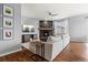 Bright living room featuring a gray sectional sofa, a fireplace, and hardwood floors at 3107 S Nepal Way, Aurora, CO 80013