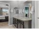 Well-lit bathroom featuring a granite vanity with double sinks and views of the main bedroom at 3107 S Nepal Way, Aurora, CO 80013