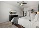 Bright main bedroom features a ceiling fan, mounted television, ensuite bathroom, and neutral decor at 3107 S Nepal Way, Aurora, CO 80013