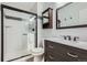 This bathroom features a walk-in shower with glass doors, modern vanity and fixtures at 461 S Kalispell Way # D, Aurora, CO 80017