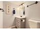 Bathroom featuring contemporary vanity, updated fixtures and framed fern art at 461 S Kalispell Way # D, Aurora, CO 80017