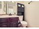 This bathroom features a burgundy vanity, mosaic tile backsplash, and a black cabinet above the toilet at 461 S Kalispell Way # D, Aurora, CO 80017