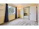 Bright bedroom with large window, closet with mirrored door, and light yellow walls at 461 S Kalispell Way # D, Aurora, CO 80017