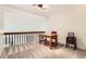 This bonus room features carpeted floors, natural light, desk and a red chair at 461 S Kalispell Way # D, Aurora, CO 80017