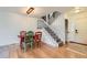 Dining room with a modern light fixture and open staircase at 461 S Kalispell Way # D, Aurora, CO 80017