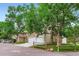 A well-kept townhome with a two-car garage is enhanced by mature trees and a charming wooden fence at 461 S Kalispell Way # D, Aurora, CO 80017