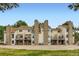 Townhome exterior showcasing stone accents, private balconies and grassy common area at 461 S Kalispell Way # D, Aurora, CO 80017