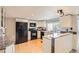 Well-lit kitchen with white cabinets, granite countertops, and stainless steel appliances at 461 S Kalispell Way # D, Aurora, CO 80017