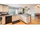 Modern kitchen with white cabinets, granite countertops, and stainless steel appliances at 461 S Kalispell Way # D, Aurora, CO 80017